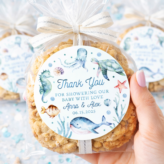 Cookie with a personalized label held by a hand against a decorative background