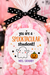 A clear cellophane bag filled with pink and white pom-pom candies, tied with a black polka-dot ribbon, and featuring a round label that reads 'you are a Spooktacular student! Mrs. Granby.