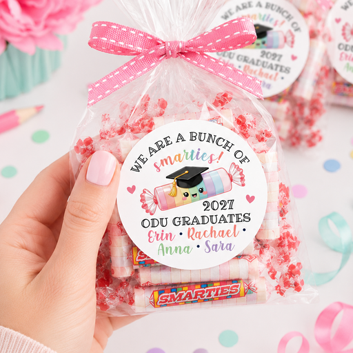 Smarties candy bag with personalized label held by a hand, surrounded by flowers and ribbons.