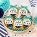 Basket of cookies with 'We're D-Fish-ally Graduates 2027' labels on a decorative background.