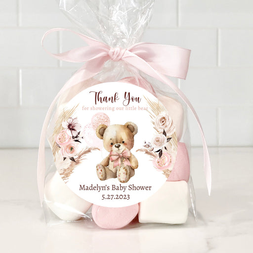 Gift set with teddy bear and flowers in cellophane wrap on a white background