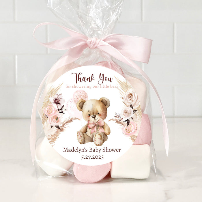 Gift set with teddy bear and flowers in cellophane wrap on a white background