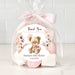 Gift set with teddy bear and flowers in cellophane wrap on a white background