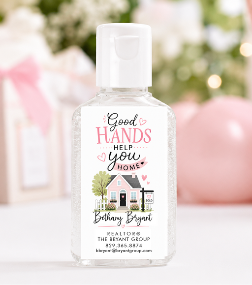 A clear plastic hand sanitizer bottle with a white cap and a custom printed white label. The label features the text 'Good HANDS HELP you HOME' with a small illustration of a house and the name 'Brittany Bryant' below it.